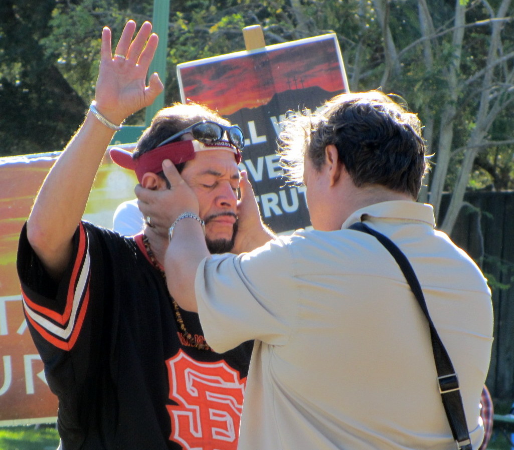 PAUL COCA PRAYS WITH MAN AT DOLORES PARK